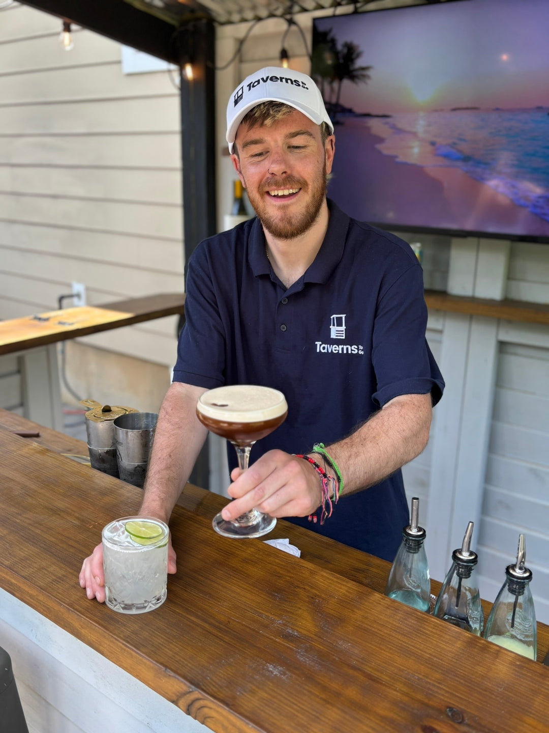 Taverns-To-Go bartender serving an espresso martini at a wooden backyard bar
