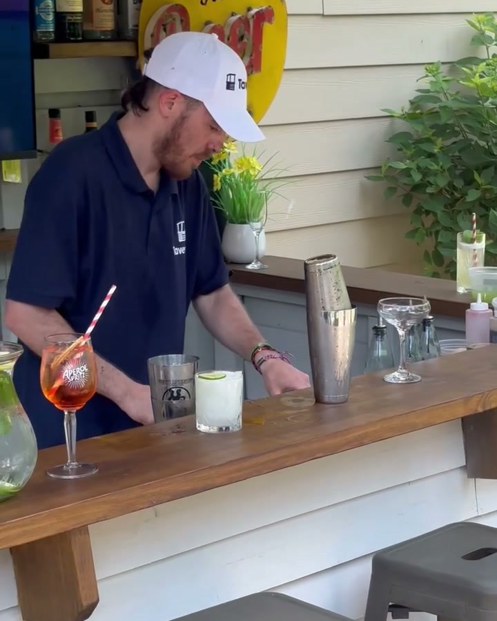 A margarita on the rocks with a lime wheel on the bar of a Taverns-To-Go outdoor bar