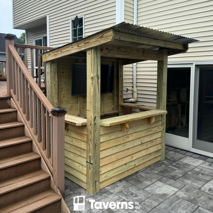 Wooden outdoor bar with a roof on a patio area, featuring the &
