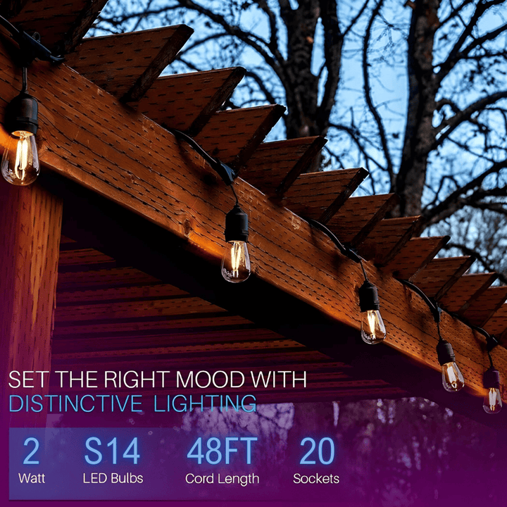 String lights on a wooden pergola with outdoor setting