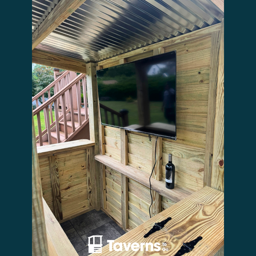 Wooden outdoor entertainment area with a TV and bottle of wine, branded &