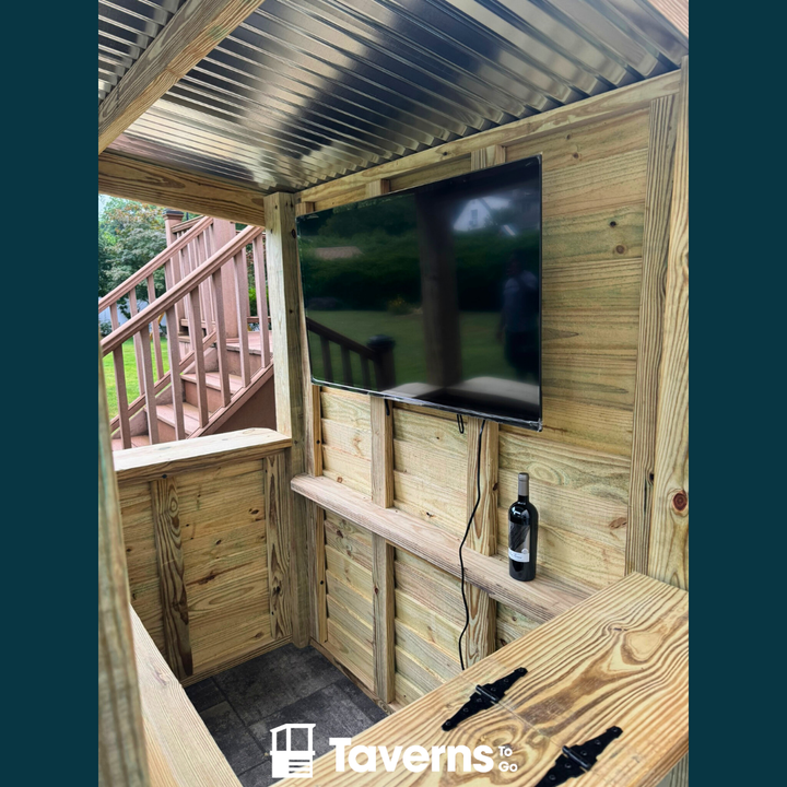Wooden outdoor entertainment area with a TV and bottle of wine, branded &