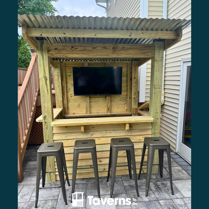 Wooden outdoor bar with TV and stools on a deck, featuring the &