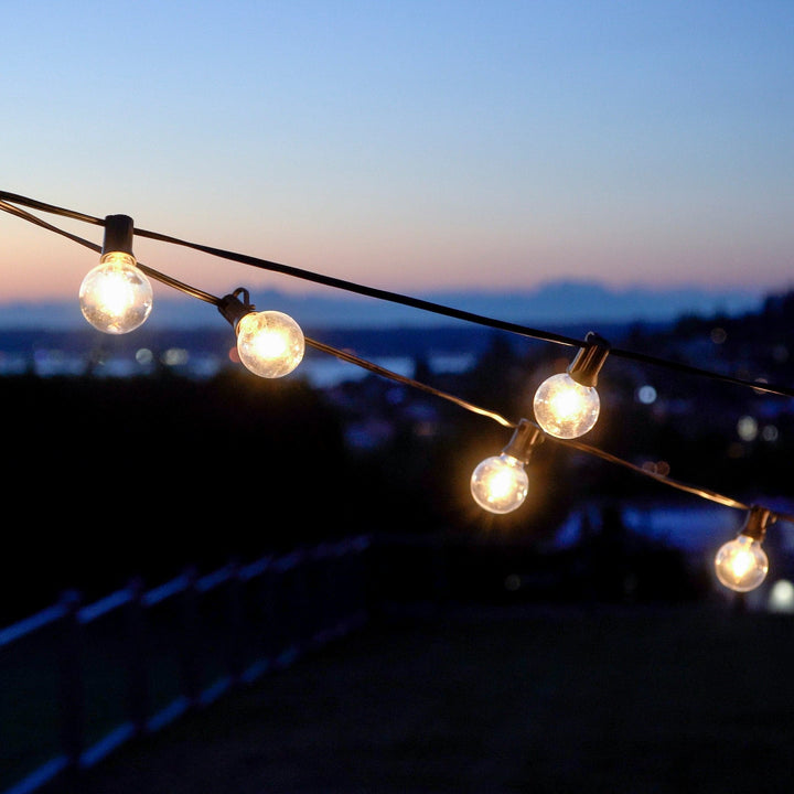 String lights with a blurred cityscape background at dusk