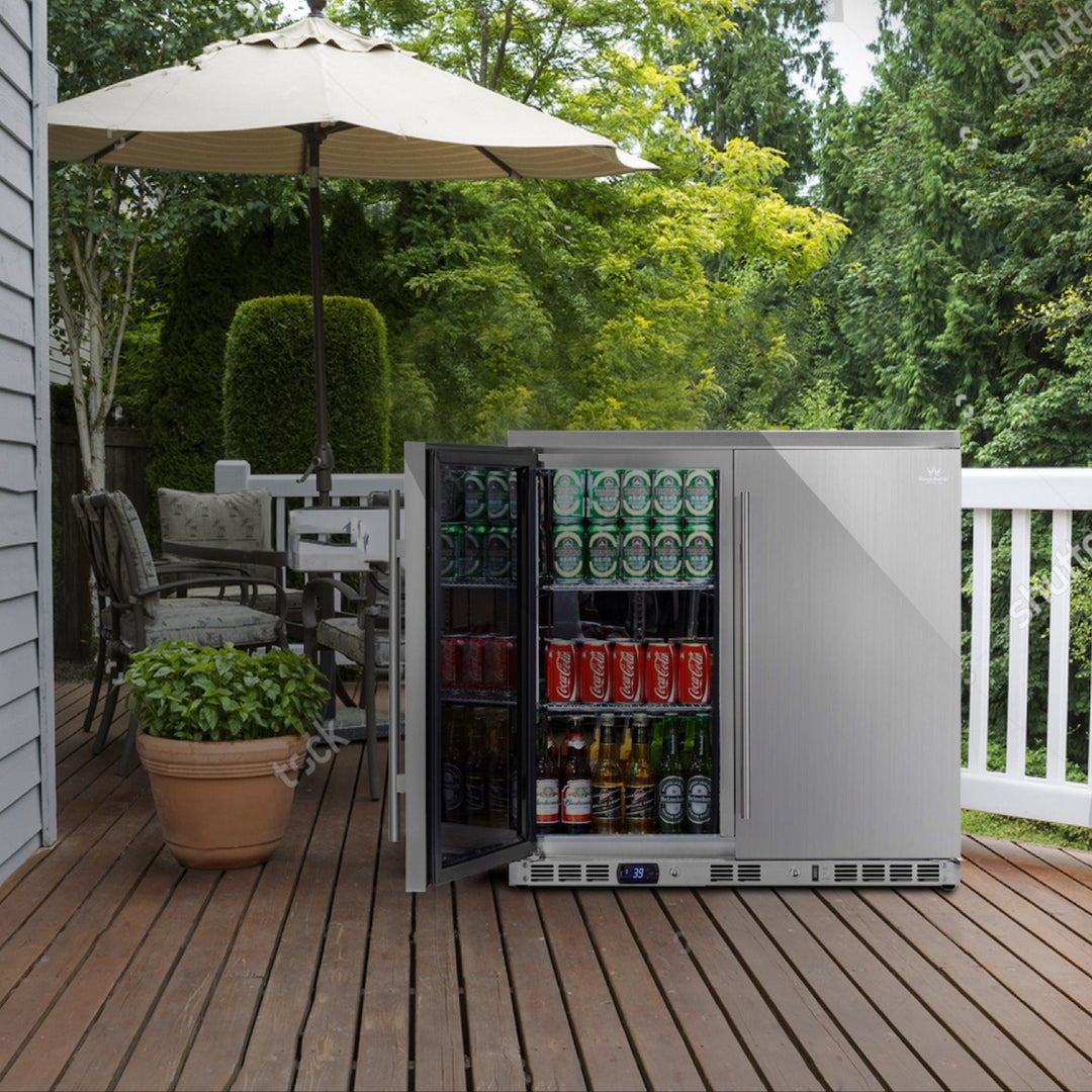 Outdoor setting with a patio table, chairs, and an open outdoor refrigerator filled with drinks.