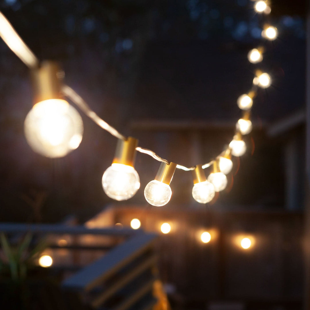 String of outdoor lights hanging against a dark background
