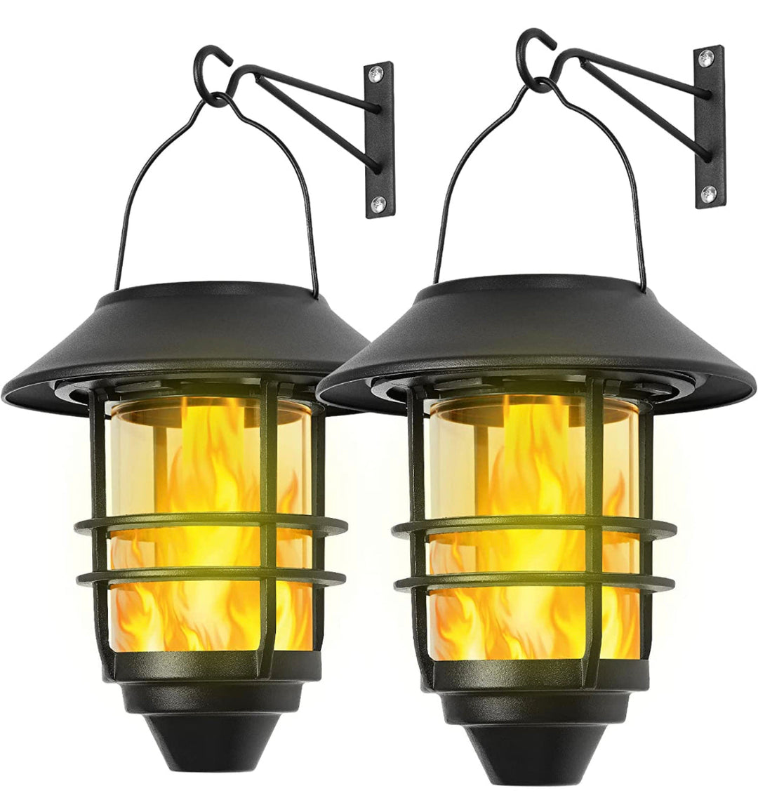 Two black solar hanging lanterns with clear heavy glass shades, mounted on walls.
